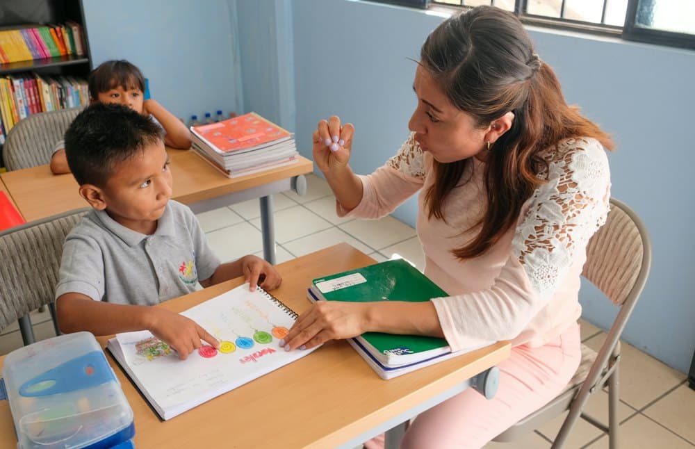 A teacher working through an exercise with a student